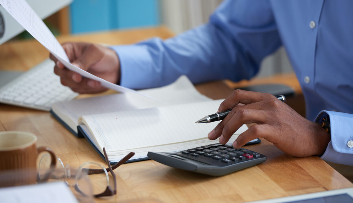 Man calculation company income tax using the tax preparation in Nigeria Guide by Taxanchor360